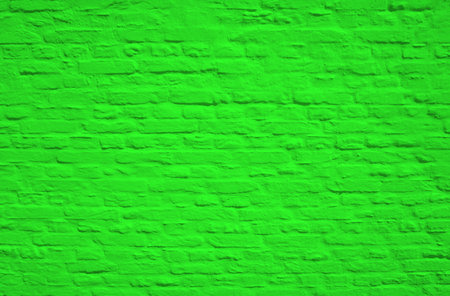 Old weathered broken brick wall texture with green colorの写真素材
