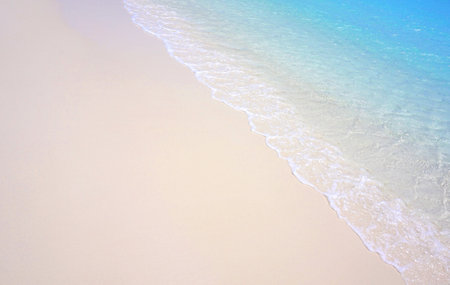 Wonderful clear blue water with waves on a sandy beachの写真素材