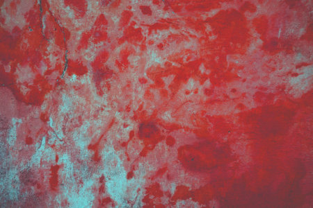 Dirty old concrete wall with weathered red grunge colorの写真素材