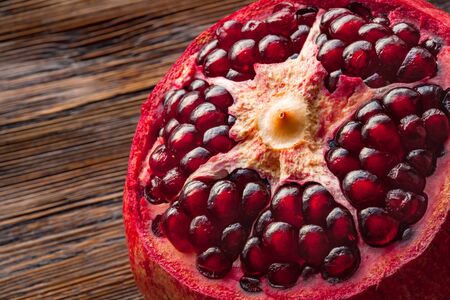 Peeled pomegranate on the wooden table