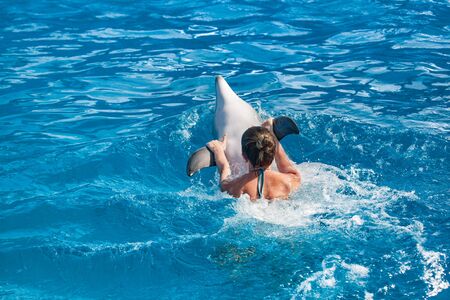 Girl swimming with a dolphinの写真素材
