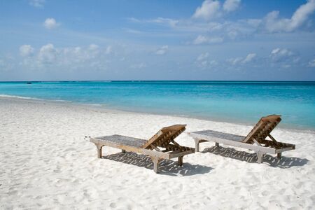 Two sunbeds on the beachの写真素材