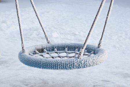 Empty blue swing in frostの写真素材