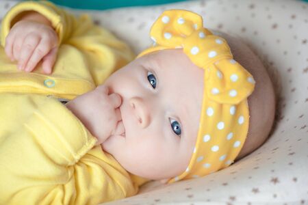 newborn baby girl in a headband	