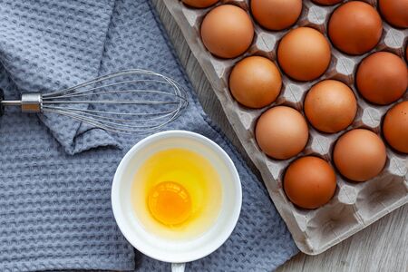 Whisk egg near the brown eggs