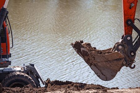 Shovel of excavator is digging an earthの写真素材