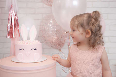 little girl and her birthday cakeの写真素材