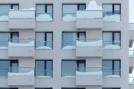 Snow falls in front of the balconiesの写真素材