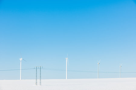 Wind turbines on snowy fieldの写真素材