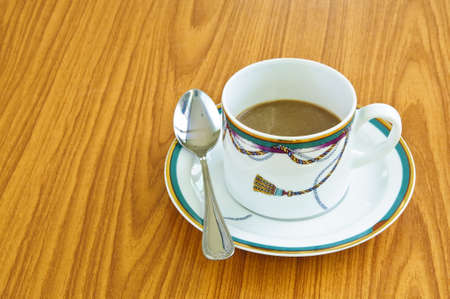 A cup of coffee on wood pattern