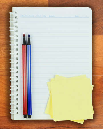 Book, Colorful pen and Post it on Parquet background 