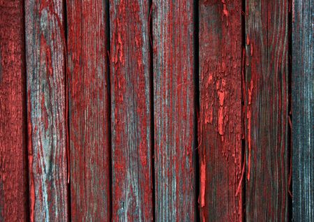 Peeling red paint. Under it are visible cracks.の写真素材