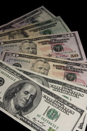 American dollars on a black background. Denominations of 100, 50, 20, and 5 dollars.の写真素材