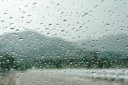 raindrops on auto glass with mountain view