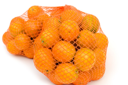 Gumquat in mesh bag on white isolatedの写真素材