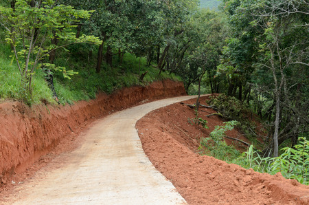 road construction in the forest with red earthの写真素材