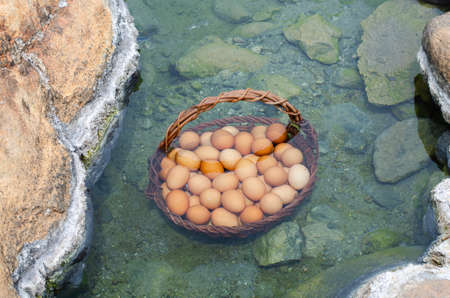 Eggs in bamboo boiling in hot springsの写真素材