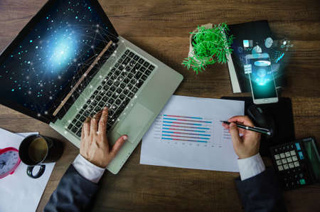 Business concept. Businessman working generic design laptop. Touching screen smartphone. Worldwide connection technology interface.の写真素材