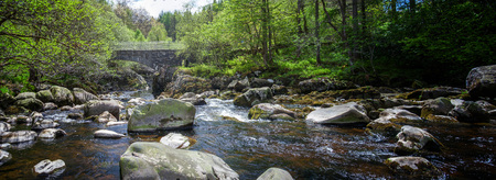 a Bridge over a boulder filled river in the southwest os Scotland, Glentrool