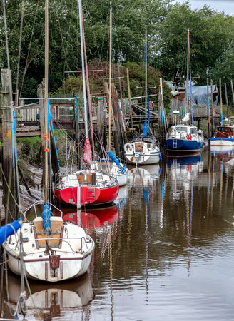 A   line of boats moored in skippool creekの写真素材