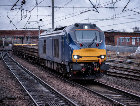a modern freight diesel   locomotive approaches the stationの写真素材