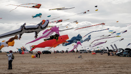 St Annes, Lancashire/United Kingdom - September 14 2024: St Annes Kite Festival. A vibrant display of colorful kites fills the sky as beachgoers enjoy a lively day by the seaside.の写真素材