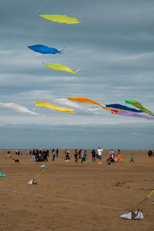 St Annes, Lancashire/United Kingdom - September 14 2024: St Annes Kite Festival. A vibrant display of colorful kites fills the sky as beachgoers enjoy a lively day by the seaside.の写真素材