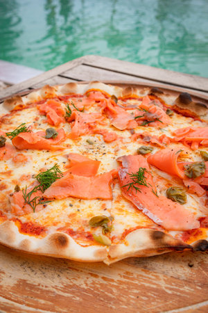 Close up, Pizza with salmon place on wooden trayの写真素材