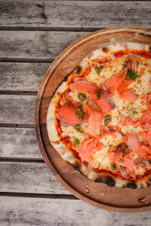 Top view, Pizza with salmon place on wooden trayの写真素材