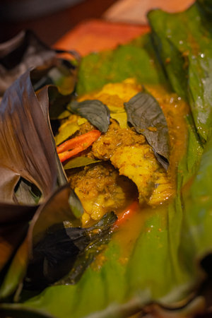 Close up, Pla ob khamin, Baked snapper with spicy thai herbs wrapped in banana leafの写真素材