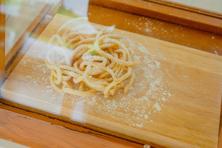 Fresh pasta noodles on wooden tray, watching through glass casesの写真素材