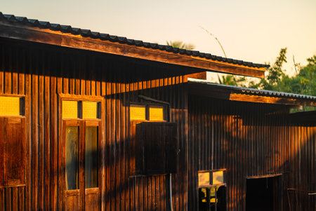 Wooden house in rustic style with sunlight casts warm tones on the wood at Chiang Rai, Thailandの写真素材
