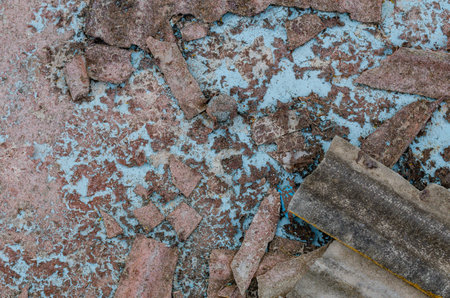 Detailed texture of dry pond and peeling blue paint with cracked roofing tilesの写真素材