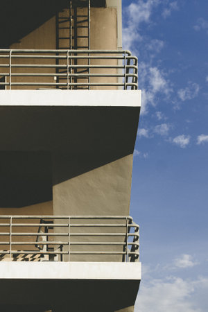 Modern building with multiple levels and clear blue sky with some cloudsの写真素材