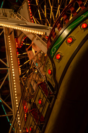 Section of a carnival ride illuminated with colorful lightsの写真素材