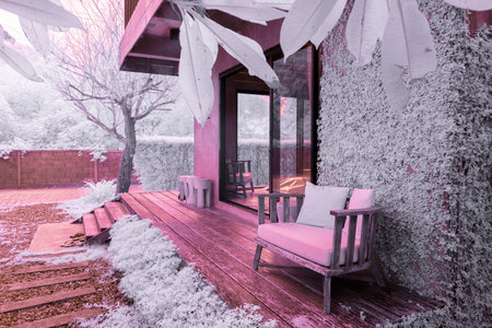 Infrared photography, a serene outdoor space featuring a wooden deck with a couple of chairsの写真素材