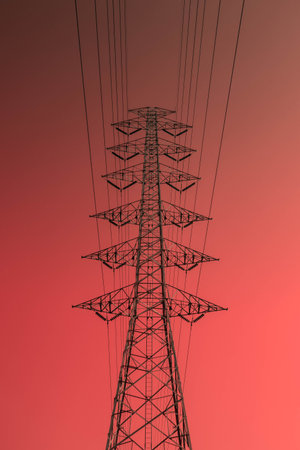 Infrared photography, a tall electrical transmission tower set against a gradient backgroundの写真素材