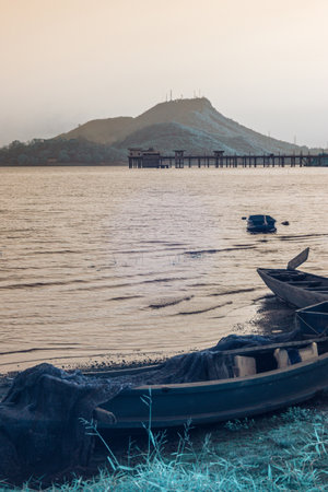 Infrared photography, a serene lakeside scene with a mountain in the backgroundの写真素材