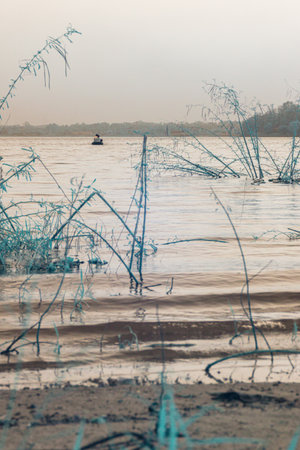 Infrared photography, a calm body of water with a small boat in the distance