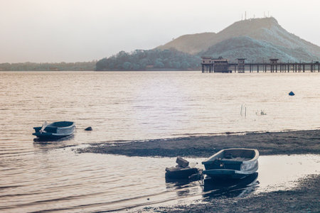 Infrared photography, a tranquil water scene with several small boats resting on a calm surfaceの写真素材