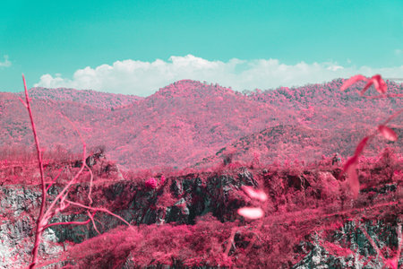 Infrared photography, a mountainous landscape with a vibrant color effect and a bright blue skyの写真素材