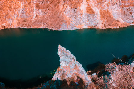 Infrared photography, a body of water, possibly a river or lake, surrounded by rocky cliffs