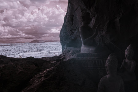 Infrared color, a cave with several Buddha statues positioned insideの写真素材