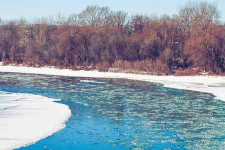 Winter landscape of the icy blue water of the Bow River, Calgary, Alberta.の写真素材