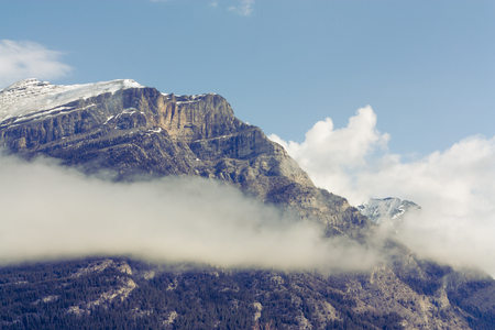 Close up of the snow capped peak of Grotto Mountain with a cloud.の写真素材
