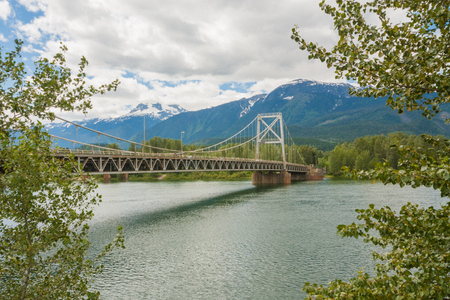 Landscape of the tree framed Revelstoke Bridge across the Columbia River.の写真素材