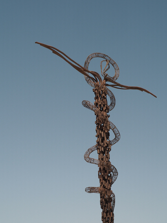 Mount Nebu, Jordan - March 6th, 2018: Brazen Serpent Monument was created by Italian artist Giovanni Fantoni, it imaginatively merges the life-saving bronze serpent set up by Moses into the desert and the cross upon which Jesus was crucified.のeditorial素材