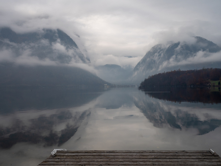 Hallstatt lake in the morning with mist from Obertraun shoreの写真素材