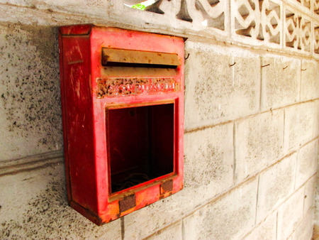 Old Rusted Red Mailbox on the Cement Blocks wallsの写真素材