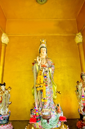 kuan yin statue on yellow backgroundの写真素材